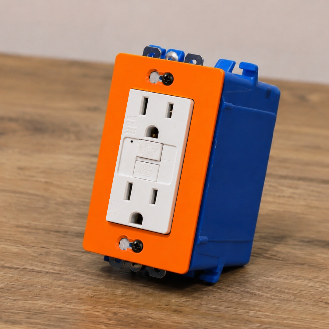 Electrical outlet with orange and blue cover on a wooden surface